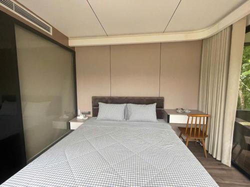 a bedroom with a large bed and a chair at Halo Retreat in Hòa Bình