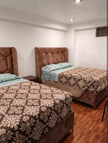 En eller flere senge i et værelse på Las Margaritas Apart Rent