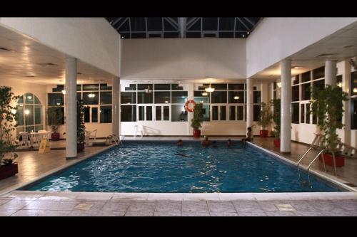 a large swimming pool in the middle of a building at Basma Residence Hotel Apartments in Sharjah