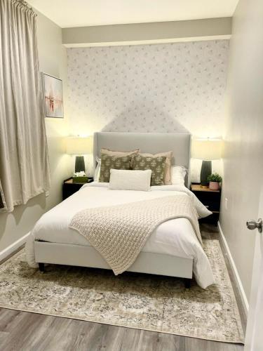 a bedroom with a white bed with a laptop on it at Central 2BR Near Yale WiFi with Washer and Dryer in New Haven