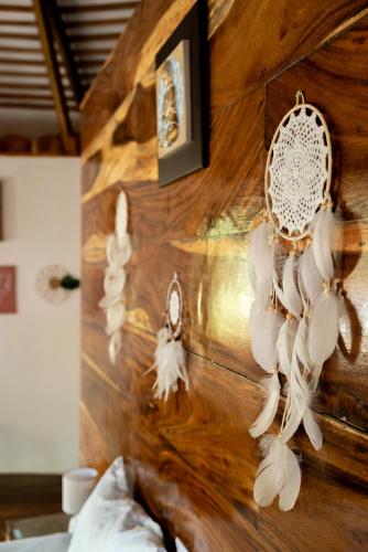 a wall with a bunch of feather decorations on it at U Story Resort in Siquijor