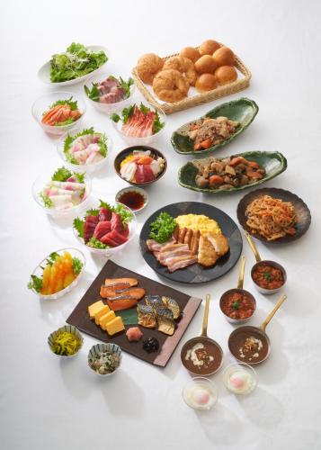 a table with plates of food and bowls of food at Ginza Capital Hotel Akane in Tokyo