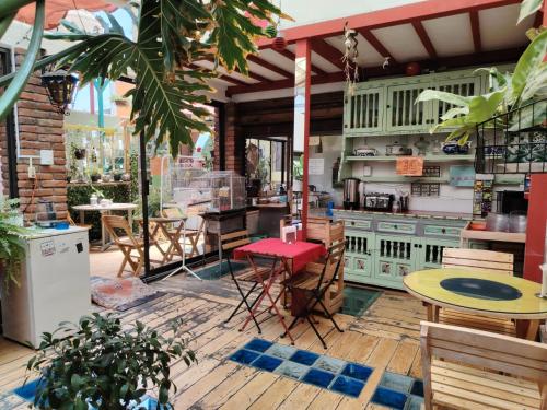 a patio with tables and chairs and a kitchen at Hostal México Airport CDMX in Mexico City
