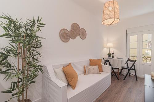 a white living room with a white couch and a table at Stylish apartment in the heart of Lisbon in Lisbon