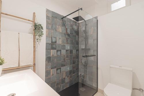 a bathroom with a glass shower with a toilet at Stylish apartment in the heart of Lisbon in Lisbon
