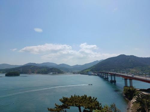 a bridge over a river with mountains in the background at Tongyeong Bridge Hotel in Tongyeong