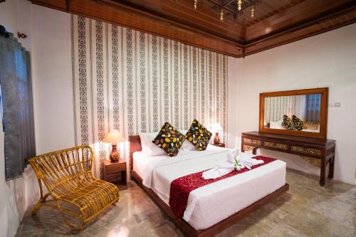 Postel nebo postele na pokoji v ubytování The Saharah Mirage Bali