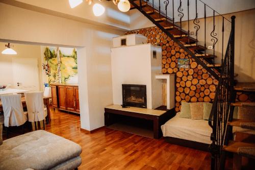 a living room with a fireplace and a staircase at Real home 1 in Sibiu
