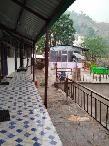 a building with a blue and white tiled floor at Hotel Snow View in Gupta Kāshi