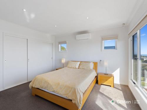 a bedroom with a bed and a large window at Bembridge Views in Ventnor