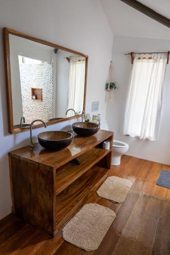 a bathroom with two sinks on a wooden counter at U Story Resort in Siquijor