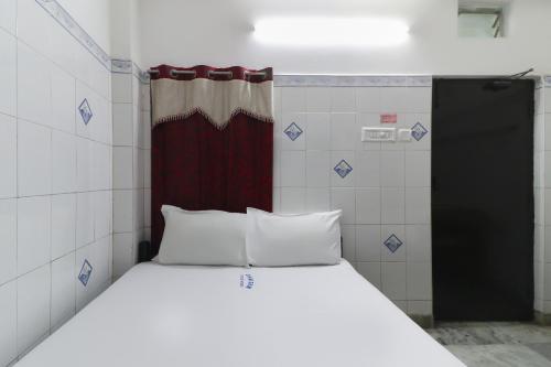 a bed in a small room with a red door at Zam zam residents in Chennai