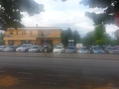 a parking lot with cars parked in front of a building at Fenix in Fontanafredda