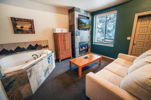a living room with a couch and a bath tub at Studio Apartment in Estes Park