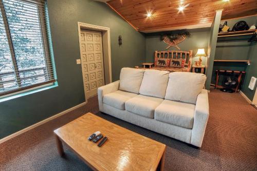 a living room with a white couch and a table at Studio Apartment in Estes Park