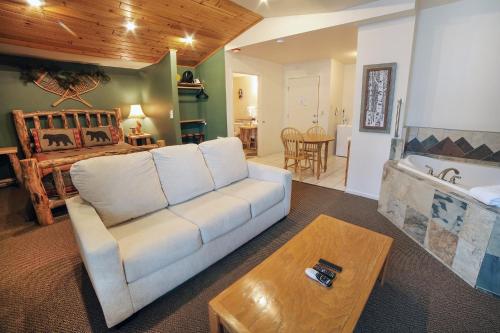 a living room with a couch and a bedroom at Studio Apartment in Estes Park