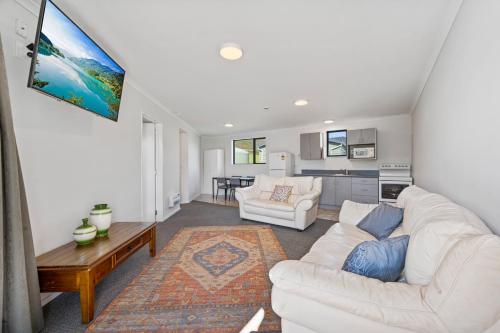 a living room with a white couch and a table at Linkwater Apartments - Two Bedroom Apartment in Linkwater