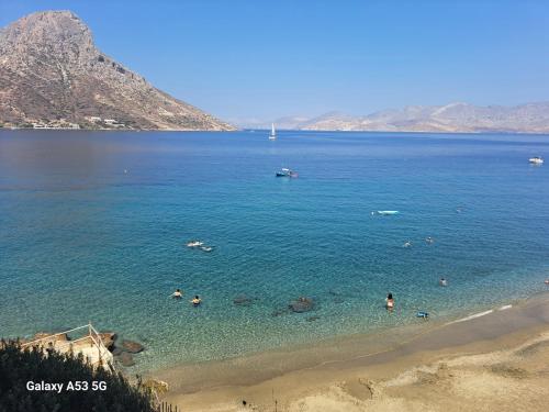 a group of people in the water at a beach at Aegean Villita on beach apartment in Kalymnos