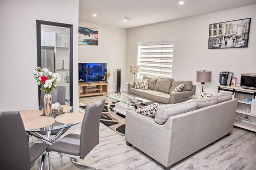 ein Wohnzimmer mit Couch und Tisch in der Unterkunft Brand-new three bedroom guest suite in the desirable neighbourhood in Prince George