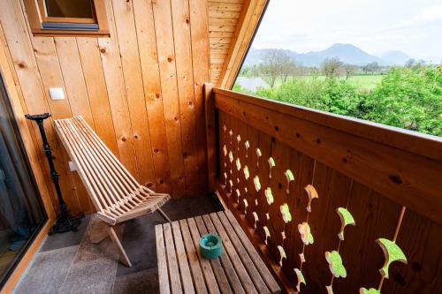 a wooden porch with a bench and a window at Turistična kmetija Grabnar in Bled