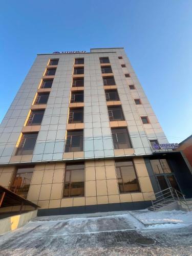 a tall building with windows on the side of it at Misoko hotel in Ulaanbaatar