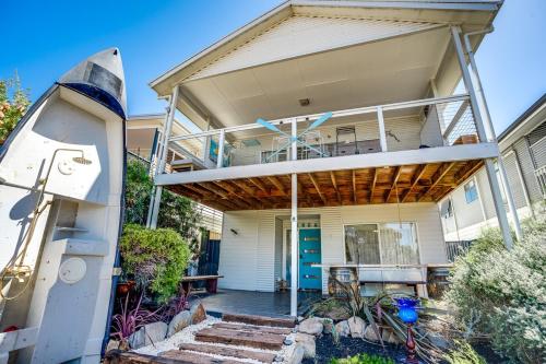 a house with a porch with a balcony at Dinga Coastal Hamptons style in Aldinga Beach