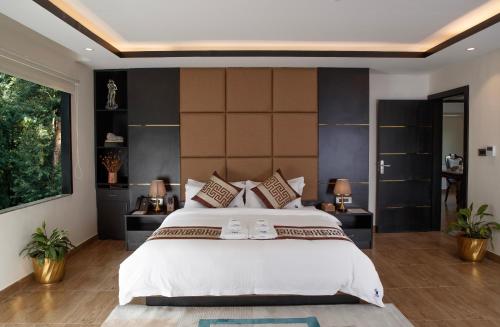 a bedroom with a large bed and a large wall at Nagarjun Resort - Embrace Tranquility Natures Retreat Beyond the City in Kathmandu
