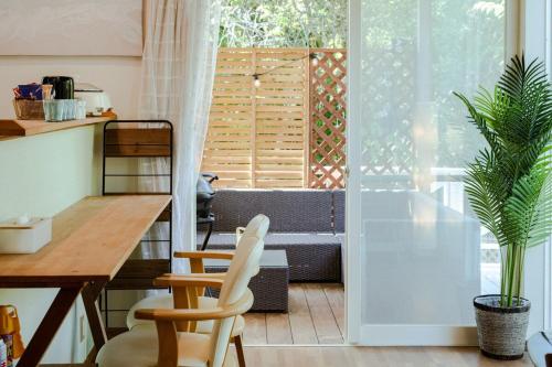 a kitchen with a table and chairs in a room at Marine Villa Ilio in Sumoto