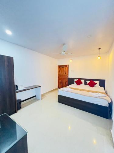 a bedroom with a bed and a desk at Sea Shore Residency in Port Blair