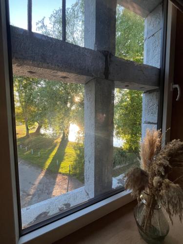 a window with a view of a field and trees at Tour de château à Barbençon in Beaumont