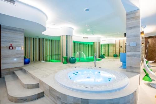 a large bathroom with a jacuzzi tub at Natura Mazur Resort & Conference in Warchały