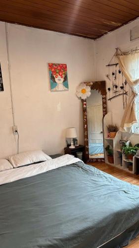 a bedroom with a bed with a blue comforter at Chút An Yên in Da Thien