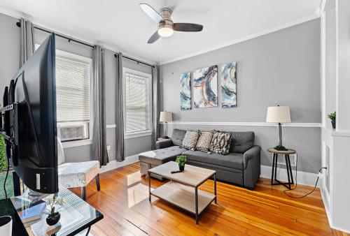 a living room with a couch and a tv at Spacious apartments near Ashmont in Boston