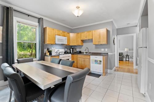 a kitchen with a table and chairs and a dining room at Spacious apartments near Ashmont in Boston