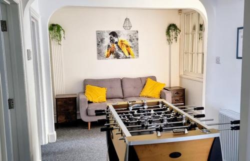 a living room with a couch and a foos ball at The Loft -Long Stays, Contractors, Professionals, Parking, WiFi, BH1, Sleeps up to 8, in Bournemouth