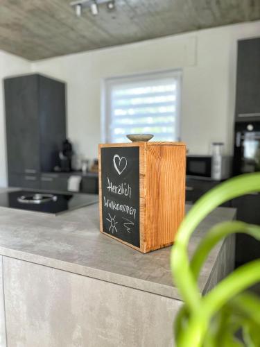 a sign sitting on top of a counter in a kitchen at Ferienwohnung Hegau Bodensee in Rielasingen-Worblingen
