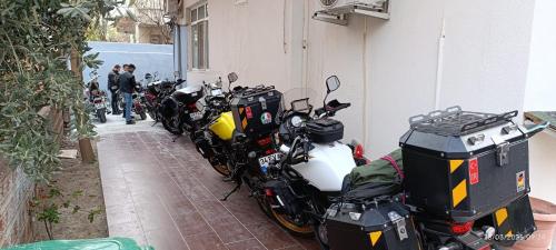 a row of motorcycles parked next to a building at Odak Pansiyon in Canakkale