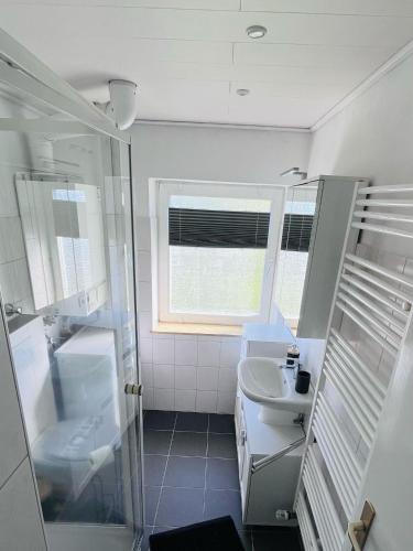 a bathroom with a shower and a sink at Nordsee in Wilhelmshaven
