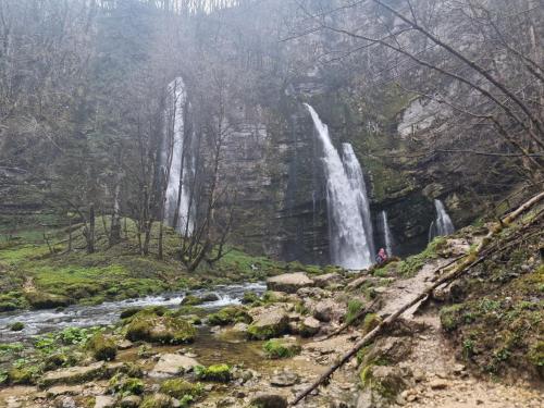 a waterfall on the side of a river in a forest at Camping Onlycamp le Martinet in Villard-Saint-Sauveur