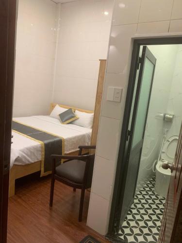 a small room with a bed and a toilet at Hai Dang Hotel in Can Tho