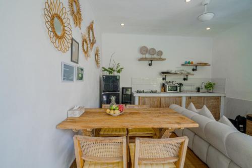 a living room with a wooden table and a couch at Villa Lemone by Bali Villa Solutions in Seminyak