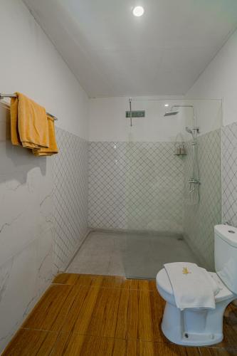 a white bathroom with a toilet and a shower at Villa Lemone by Bali Villa Solutions in Seminyak