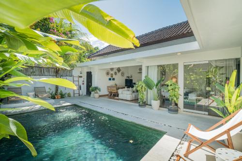a villa with a swimming pool and a house at Villa Lemone by Bali Villa Solutions in Seminyak