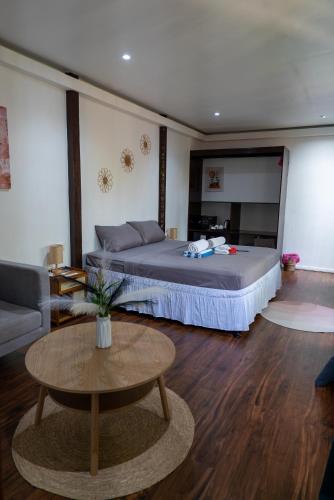 a bedroom with a bed and a table and a couch at U Story Resort in Siquijor