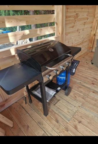 a bbq grill sitting on a wooden deck at Apartament Zacisze 2 in Przemyśl