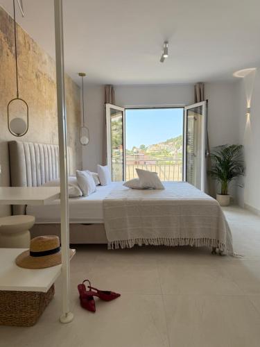 a bedroom with a bed and a large window at Oleander Apartment & Room Centar in Hvar