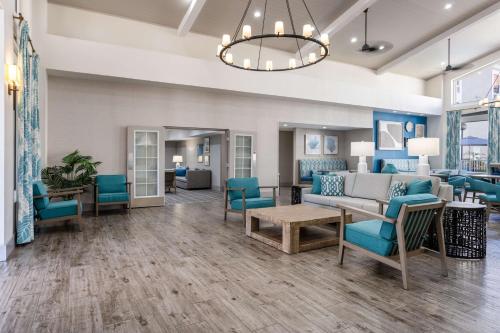 a lobby with blue chairs and a couch at Hampton Inn & Suites Venice Bayside South Sarasota in Venice
