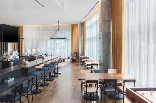 a restaurant with a row of tables and chairs at Hyatt Regency Houston Galleria in Houston