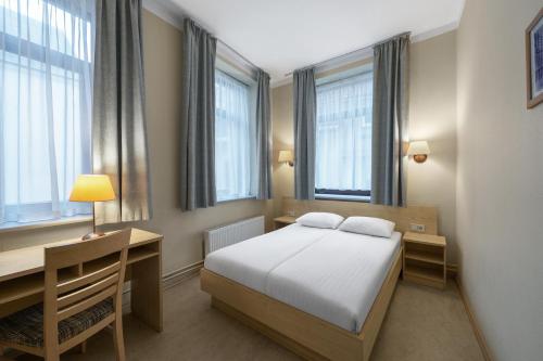 Postel nebo postele na pokoji v ubytování Rija Domus Hotel