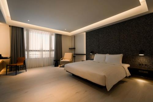 Una cama o camas en una habitación de XIUXI Anping Hotel